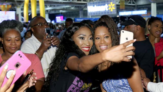 Regina King (R) takes a selfie with a fan at Essence Festival 2018 on July 6, 2018, in New Orleans.