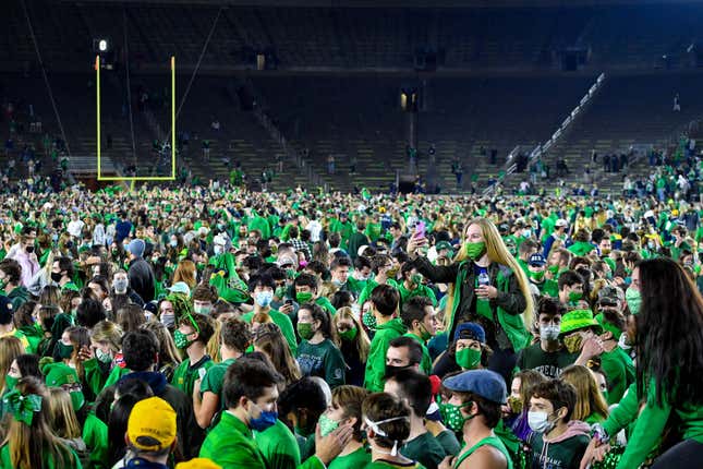 Notre Dame students celebrate on the field after the Irish’s OT win over Clemson.