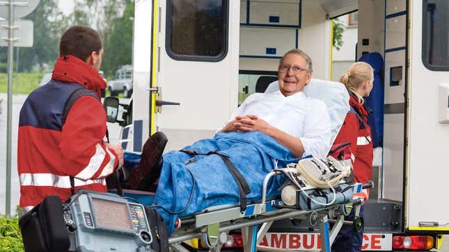 Image for article titled Babbling, Grinning Mitch McConnell Demands EMTs Loading Him On Stretcher Vote Yes On Healthcare Bill