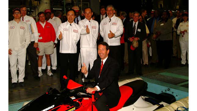 A photo of a Honda exec sat on a jet ski in the company's factory. 