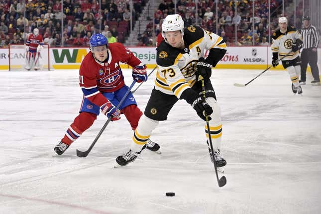 Apr 13, 2023; Montreal, Quebec, CAN; Boston Bruins defenseman Charlie McAvoy (73) plays the puck and Montreal Canadiens forward Brendan Gallagher (11) forechecks during the second period at the Bell Centre.