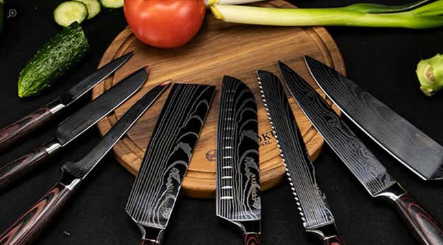 Seven Seido Japanese knives sprawled across a cutting board.