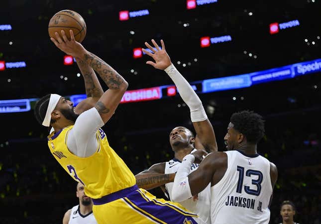 Apr 28, 2023; Los Angeles, California, USA;Los Angeles Lakers forward Anthony Davis (3) is defended by Memphis Grizzlies forward Xavier Tillman (2) and forward Jaren Jackson Jr. (13) as he goes up for a shot in the first quarter of game six of the 2023 NBA playoffs at Crypto.com Arena.