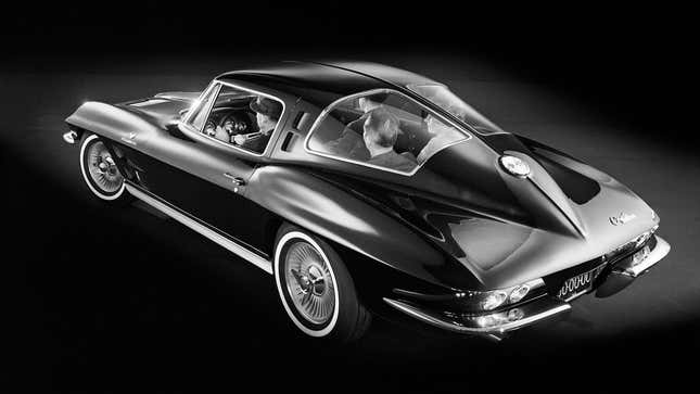General Motors black-and-white press image of a four-seat prototype C2 Corvette Sting Ray, viewed from the rear quarter and slightly above.