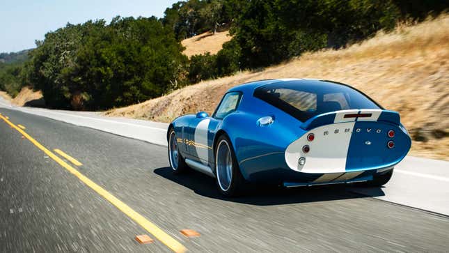 A photo of the rear of a Renovo Coupe EV as it drives down a highway. 