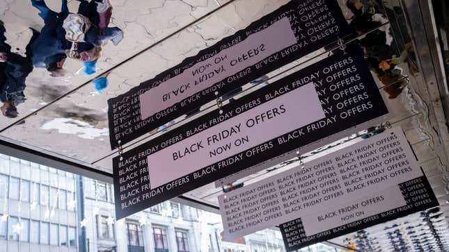 Black Friday signs hanging over shoppers in London.