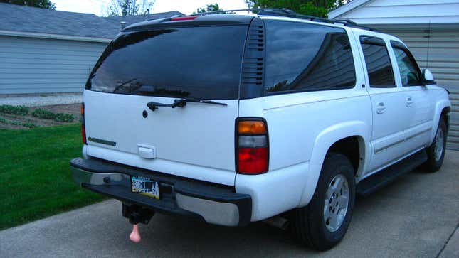 A white SUV with truck nuts fitted. 
