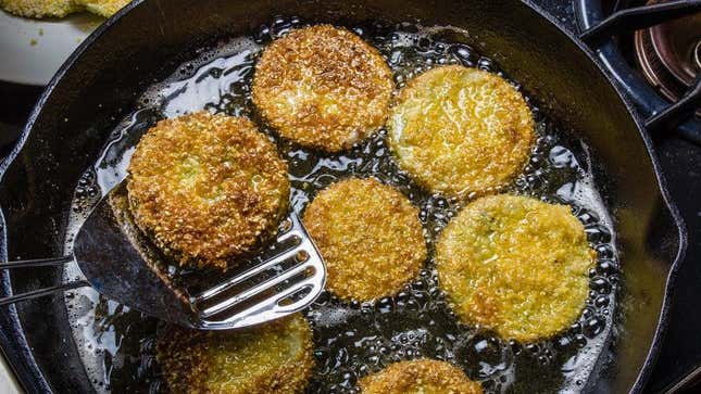 Fried green tomatoes in skillet with oil