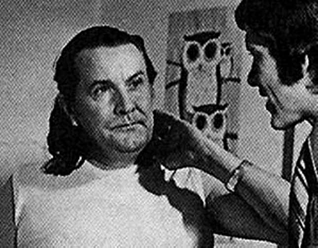 Filmmaker Ed Wood talks to another man on the set of a movie.