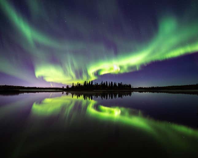 The aurora reflect off a Canadian lake.