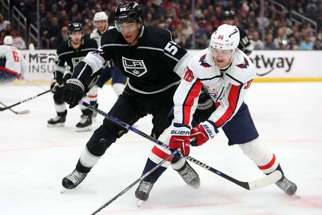 Mar 6, 2023; Los Angeles, California, USA;  Washington Capitals right wing Nicolas Aube-Kubel (96) and Los Angeles Kings center Quinton Byfield (55) fights for the puck during the first period at Crypto.com Arena.