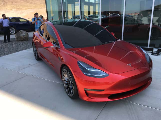 Tesla tries to turn its customers into true believers. One of its strategies is inviting car owners to its product launch parties, one of which will happen this Friday as more than 2,000 Tesla owners and their guests descend on the Gigafactory. The team rolled out a Model 3 demo model, although the car appears to be for demonstration only. Workers push the car back across the parking lot manually.
