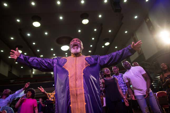 Worshippers pray during Sunday service at the House of Praise church in London.