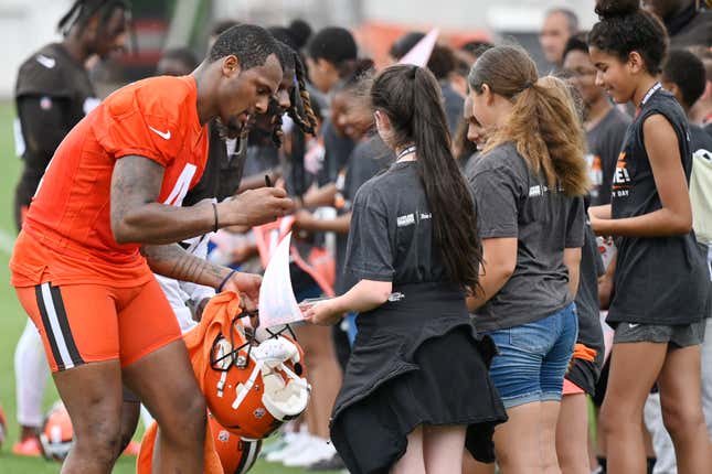 Cleveland Browns quarterback Deshaun Watson signs autographs after an NFL football practice at the team’s training facility, Wednesday, June 1, 2022, in Berea, Ohio.