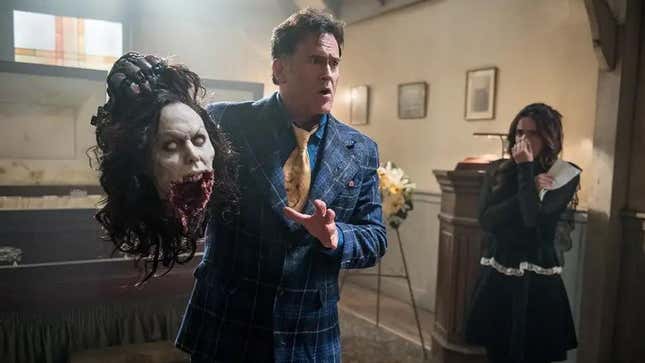 Bruce Campbell holds a severed head in Ash vs. Evil Dead