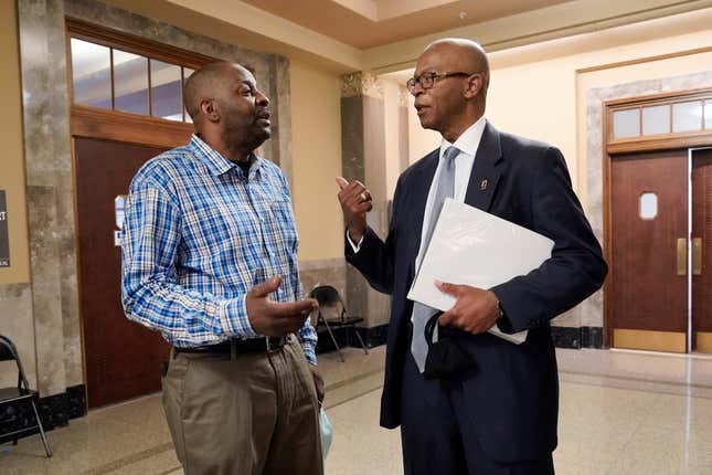 Emmit Gooden, left, mayor of Mason, Tenn., talks with attorney Terry Clayton after a hearing in Davidson County Chancery Court on Wednesday, April 6, 2022, in Nashville, Tenn. Clayton is representing the town leaders of Mason, a small town facing a takeover of its finances by the state comptroller.