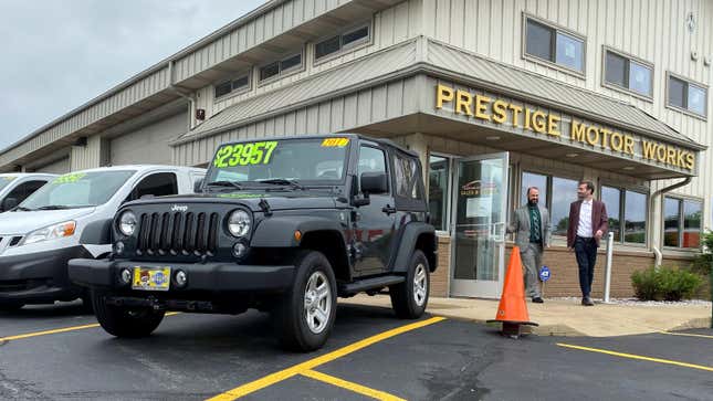 Alex Tovstanovsky, owner of used-car dealer Prestige Motor Works, checks on depleted inventory with his general manager Ryan Caton after sales jumped in May following two down months because of the coronavirus disease (COVID-19) pandemic in Naperville, Illinois, U.S. May 28, 2020.
