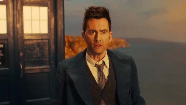 Standing outside his TARDIS, the Tenth Doctor looks alarmed and confused.