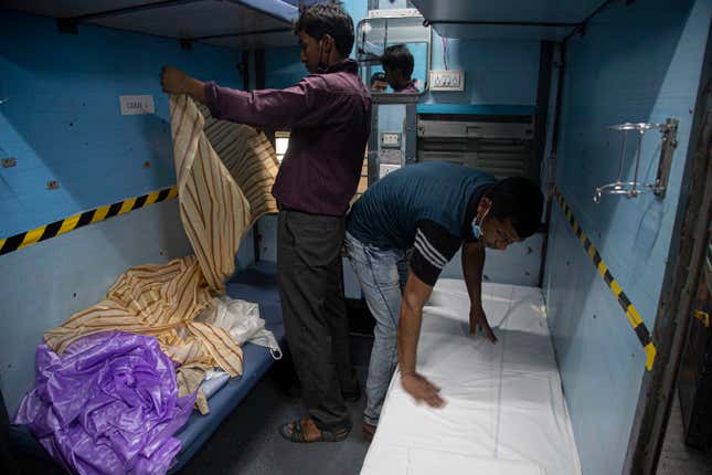 Railway employees fixing a mosquito net in the converted quarantine wards.