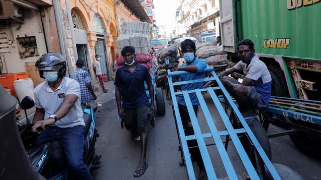 FILE PHOTO: Men wait with their carts at a market, amid the country’s economic crisis in Colombo, Sri Lanka, April 7, 2022. REUTERS/Dinuka Liyanawatte/File Photo