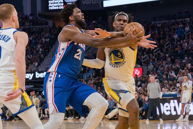 Mar 24, 2023; San Francisco, California, USA;  Philadelphia 76ers center Joel Embiid (21) is fouled in the act of shooting by Golden State Warriors forward Kevon Looney (5) during the second quarter at Chase Center.