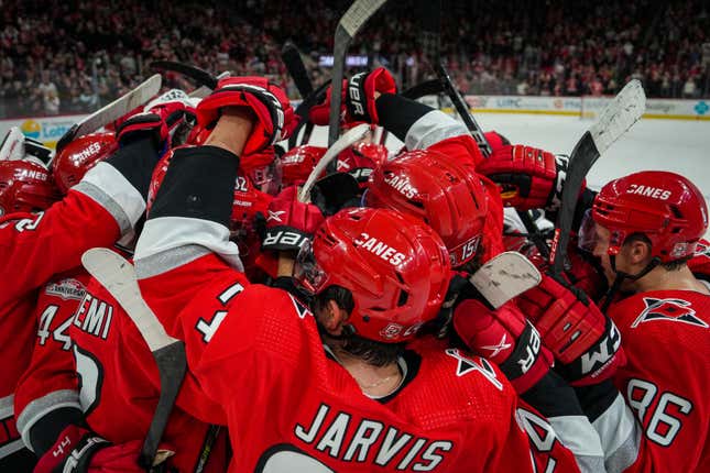 The Carolina Hurricanes celebrate after defeating the Los Angeles Kings in overtime.