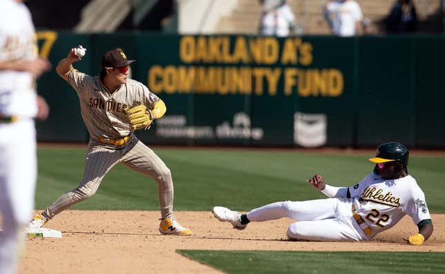 Sep 16, 2023; Oakland, California, USA; San Diego Padres second baseman Ha-Seong Kim (7) throws over Oakland Athletics center fielder Lawrence Butler (22) to complete a double play during the sixth inning at Oakland-Alameda County Coliseum.