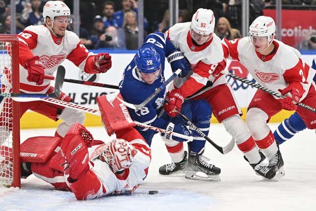 Apr 2, 2023; Toronto, Ontario, CAN; Toronto Maple Leafs forward Sam Lafferty (28) battles for a loose puck with Detroit Red Wings forward Marco Kasper (92) in front of goalie Alex Nedeljkovic (39) in the first period at Scotiabank Arena.