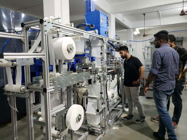 The engineering team checks one of the pad-making machines in Saral Designs’ headquarters.
