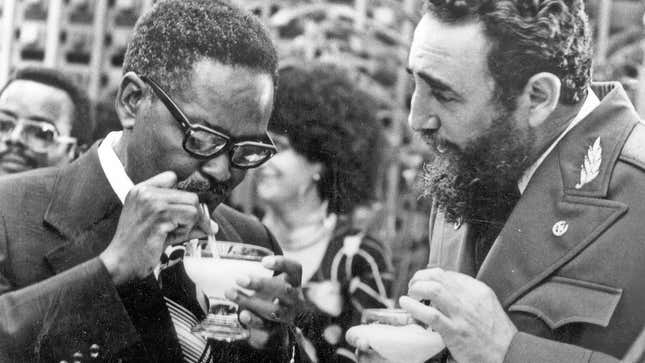 Cuban Prime Minister Fidel Castro, right, shows Angolan Movimento Popular de Liberta��o de Angola (MPLA) President Agostinho Neto how to drink a daikiri, a frozen Cuban drink made with rum, ice and sugar, during a reception in his honor in Havana, July 28, 1976.