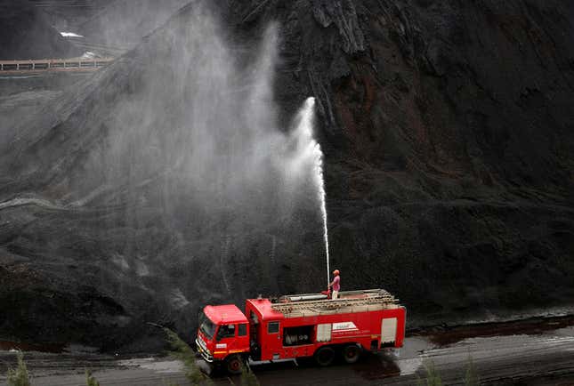 Water is sprayed over coal at an Essar Power coal-fired electrical plant in Gujarat.