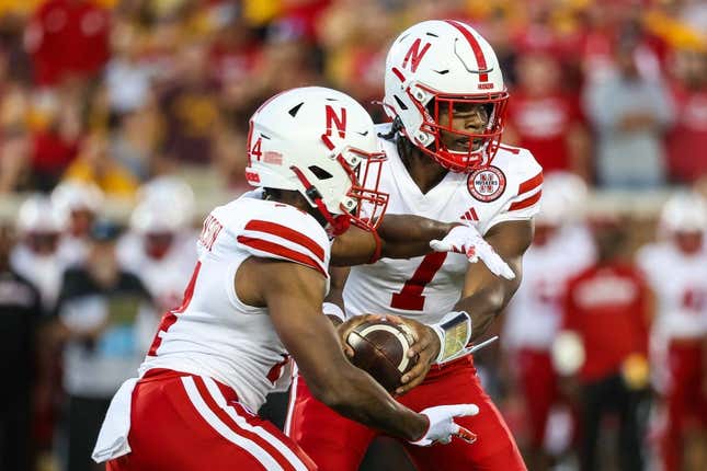 Aug 31, 2023; Minneapolis, Minnesota, USA; Nebraska Cornhuskers quarterback Jeff Sims (7) hands the ball off to running back Rahmir Johnson (14) during the second quarter against the Minnesota Golden Gophers at Huntington Bank Stadium.