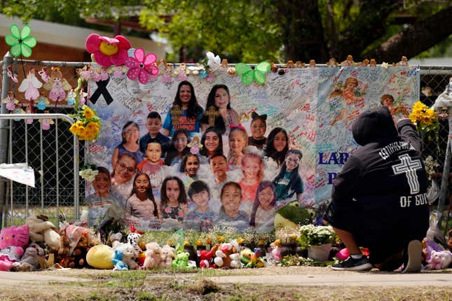 A mourner stops to pay his respects at a memorial at Robb Elementary School, created to honor the victims killed in the recent school shooting, June 9, 2022, in Uvalde, Texas.