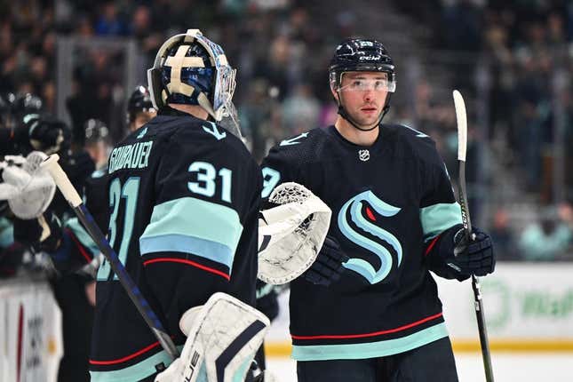 Feb 26, 2023; Seattle, Washington, USA; Seattle Kraken defenseman Vince Dunn (29) celebrates with Seattle Kraken goaltender Philipp Grubauer (31) after scoring a goal against the Toronto Maple Leafs during the first period at Climate Pledge Arena.