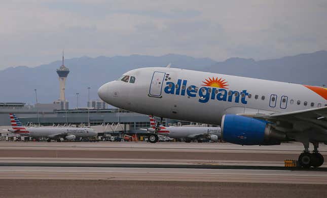 An Allegiant Air airplane on the runway of Harry Reid International Airport on a hazy day.