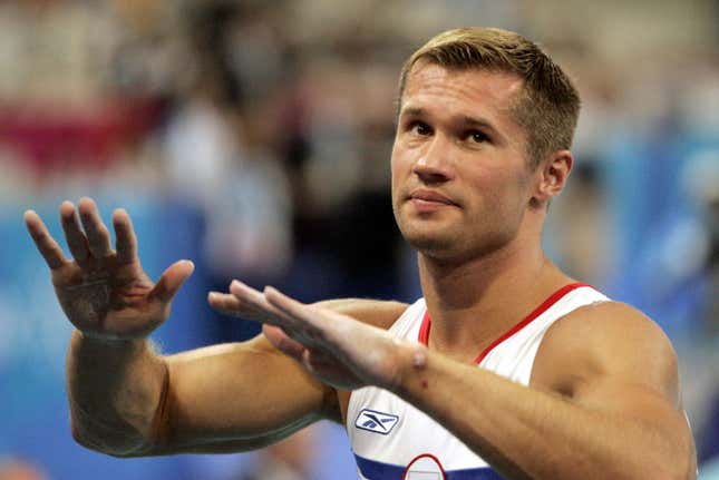Russian gymnast Alexei Nemov tries to calm the crowd down.