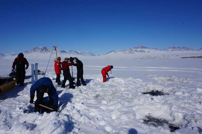 Photo of scientists working on frozen Arctic lake