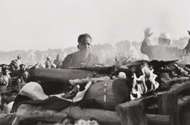 Gandhi’s secretary watches the first flames of the funeral pyre, Delhi, India, 1948.