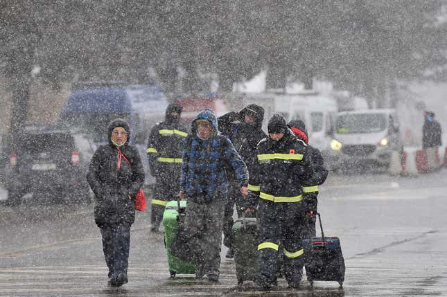 People fleeing Ukraine in the snow, October 2022. 
