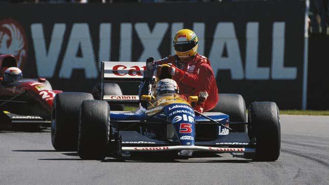 Nigel Mansell lifts Ayrton Senna, as the McLaren driver rides on a Mansell's Williams sidepod at the end of the 1991 British Grand Prix.