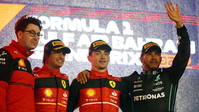 Mattia Binotto, Carlos Sainz, Charles LecLerc and Lewis Hamilton on the F1 podium.