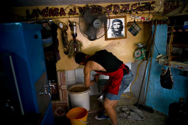Winemaker Orestes Esteve, prepares a jug of wine at his house in Havana, Cuba. (AP Photo/Ramon Espinosa)