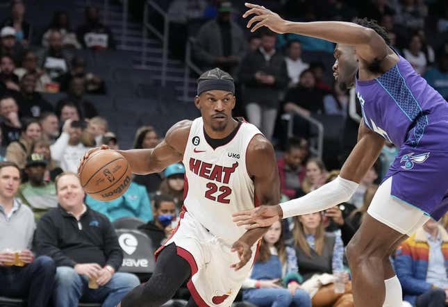 Feb 25, 2023; Charlotte, North Carolina, USA; Miami Heat forward Jimmy Butler (22) drives against Charlotte Hornets center Mark Williams (5) in the first quarter at Spectrum Center.