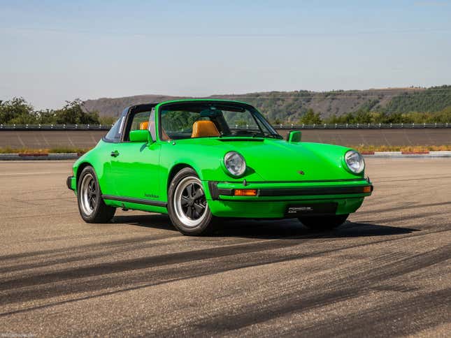 A bright green 1976 Carrera 3.0 is parked on skidmarked pavement.