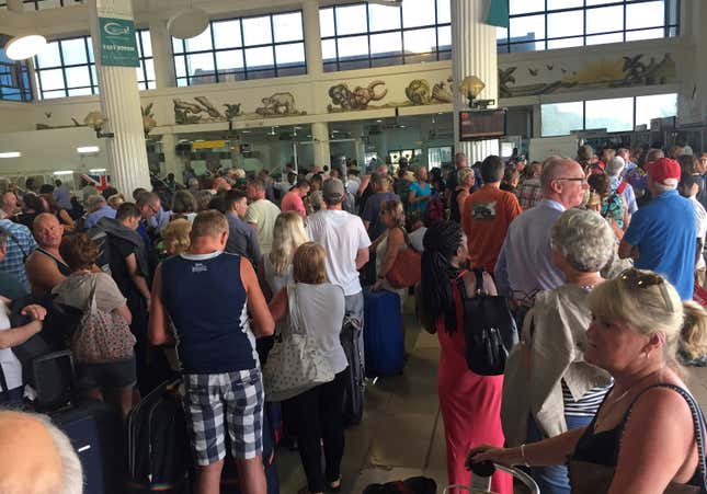 Tourists gather at the airport in Banjul as tour operators send in extra flights to evacuate them Wednesday Wednesday Jan. 18, 2017. As the political crisis deepened, special flights were being organized to evacuate British and other tourists from Gambia, where the threat of a regional military intervention loomed to force Jammeh to step down.