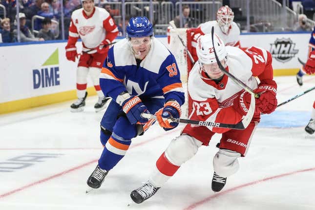 Mar 4, 2023; Elmont, New York, USA;  New York Islanders center Casey Cizikas (53) and Detroit Red Wings left wing Lucas Raymond (23) chase after the puck in the second period at UBS Arena.