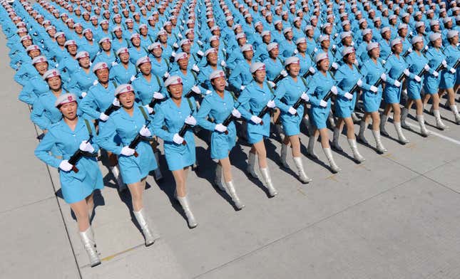 Female members of Chinese militia march in formation during a training session for the 60th National Day Parade Village on the outskirts of Beijing