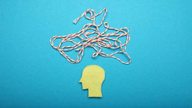 A simple yellow paper cutout of a man's silhouette in profile against a solid blue background, with a jumbled pile of string overhead to symbolize scattered thoughts