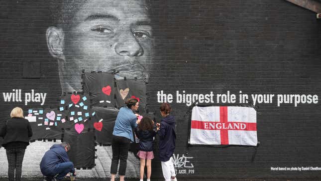 Local residents put messages of support on the plastic that covers offensive graffiti on the vandalized mural of Manchester United striker and England player Marcus Rashford.