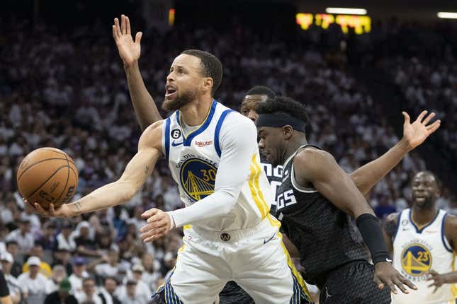 April 30, 2023; Sacramento, California, USA; Golden State Warriors guard Stephen Curry (30) shoots the basketball against Sacramento Kings forward Harrison Barnes (40) and guard Terence Davis (3) during the third quarter in game seven of the 2023 NBA playoffs first round at Golden 1 Center.